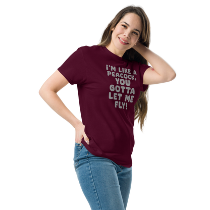 "I'm like a peacock, you gotta let me fly!" printed on a maroon unisex classic tee worn by a female