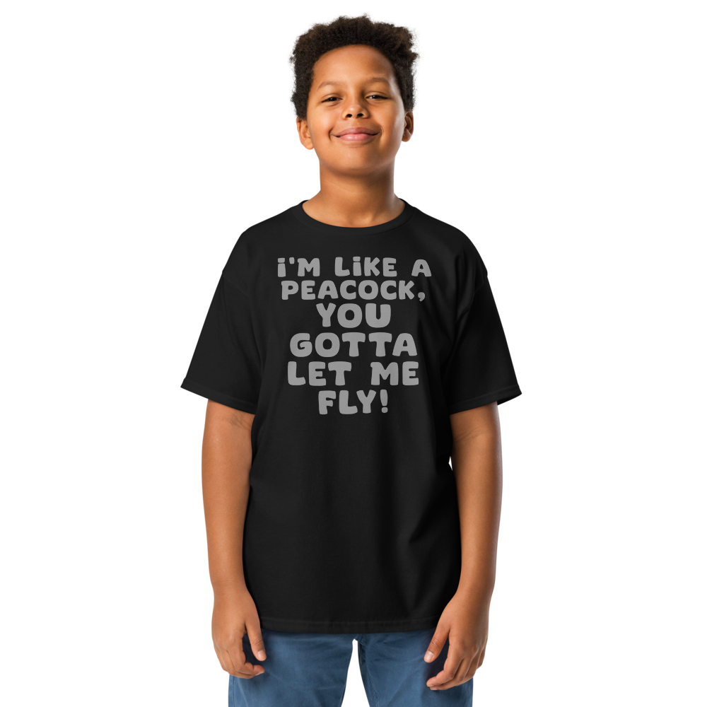 "I'm like a peacock, you gotta let me fly!" printed on a black youth classic tee worn by a male