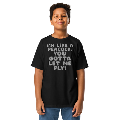 "I'm like a peacock, you gotta let me fly!" printed on a black youth classic tee worn by a male