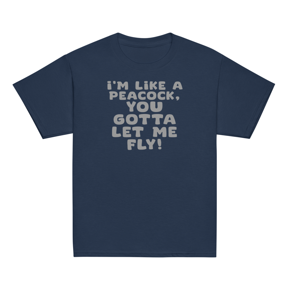 "I'm like a peacock, you gotta let me fly!" printed on a navy youth classic tee laying on a flat surface