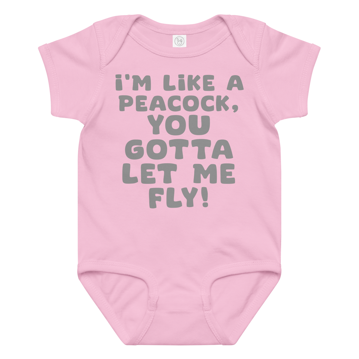 "I'm like a peacock, you gotta let me fly!" printed on a pink baby jersey bodysuit laying on a flat surface amongst other clothes