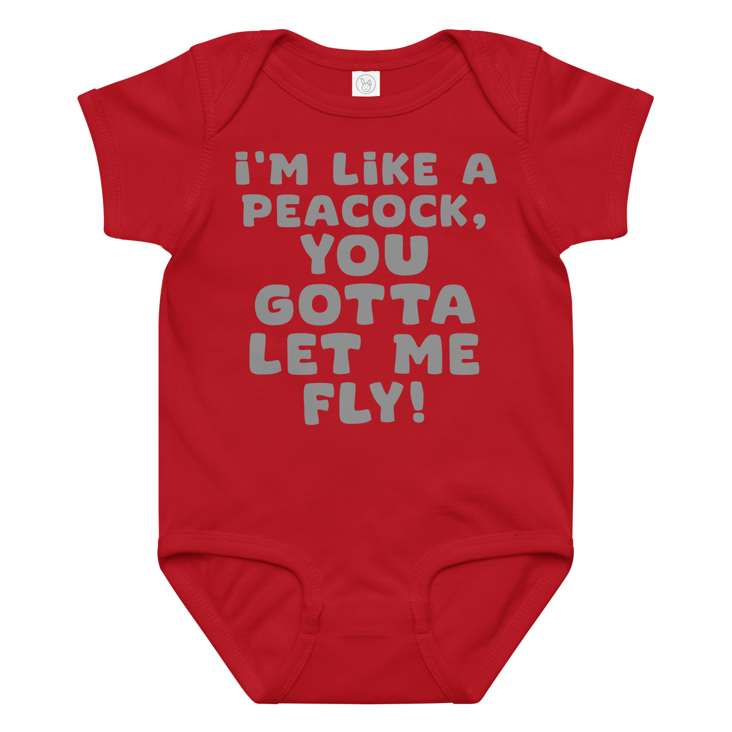 "I'm like a peacock, you gotta let me fly!" printed on a red baby jersey bodysuit laying on a flat surface amongst other clothes