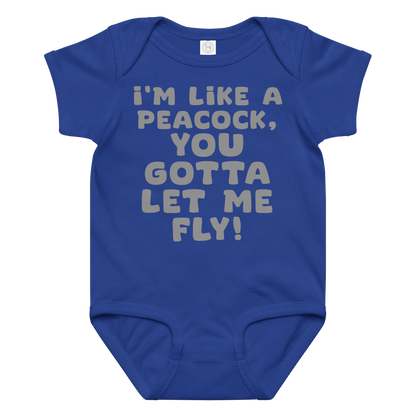 "I'm like a peacock, you gotta let me fly!" printed on a royal baby jersey bodysuit laying on a flat surface amongst other clothes
