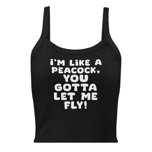 "I'm like a peacock, you gotta let me fly!" printed on a solid black blend women's micro-rib tanktop laying on a flat surface