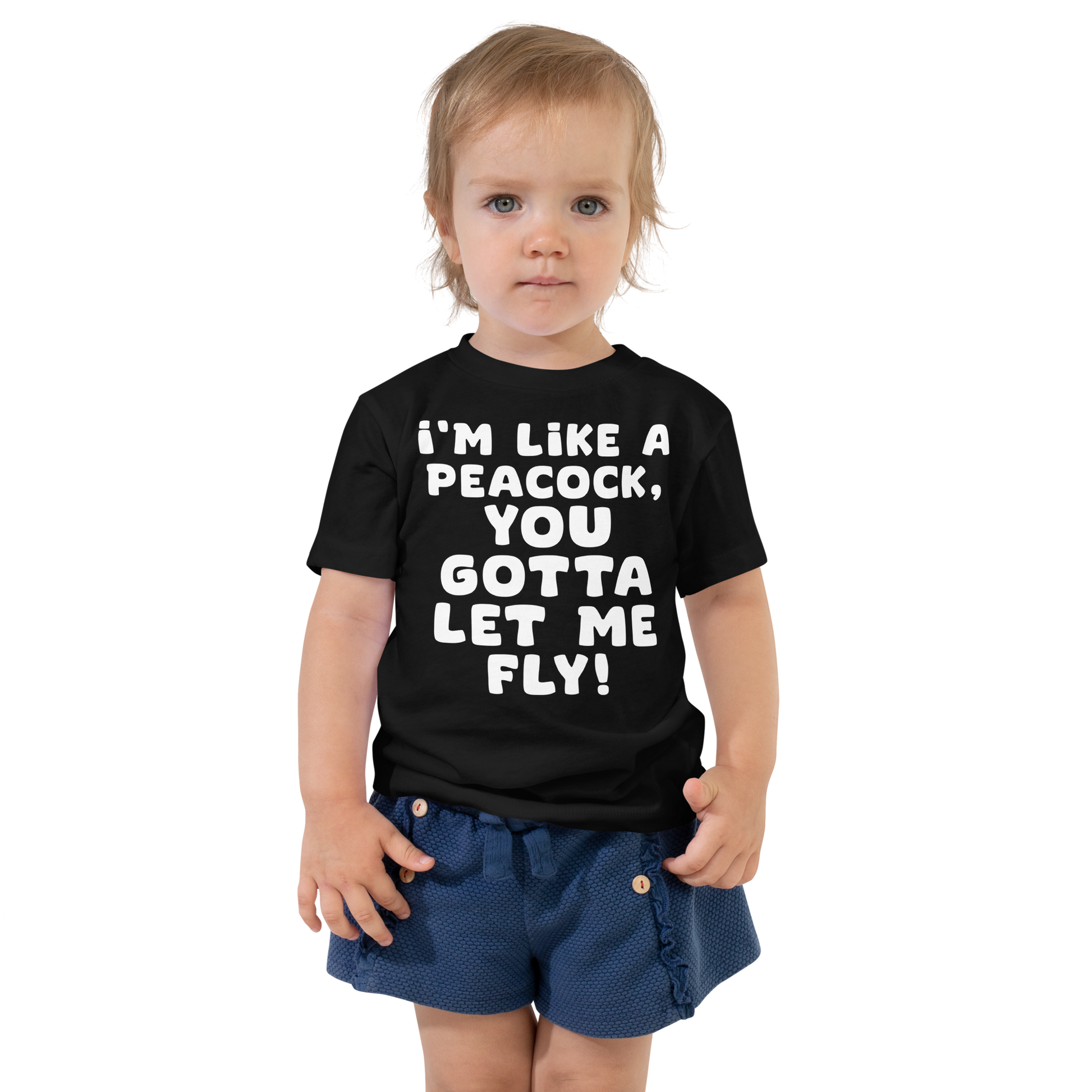 "I'm like a peacock, you gotta let me fly!" printed on a black toddler short sleeve tee worn by a female