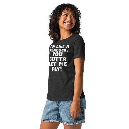 "I'm like a peacock, you gotta let me fly!" printed on a dark grey heather women's relaxed t-shirt worn by a female