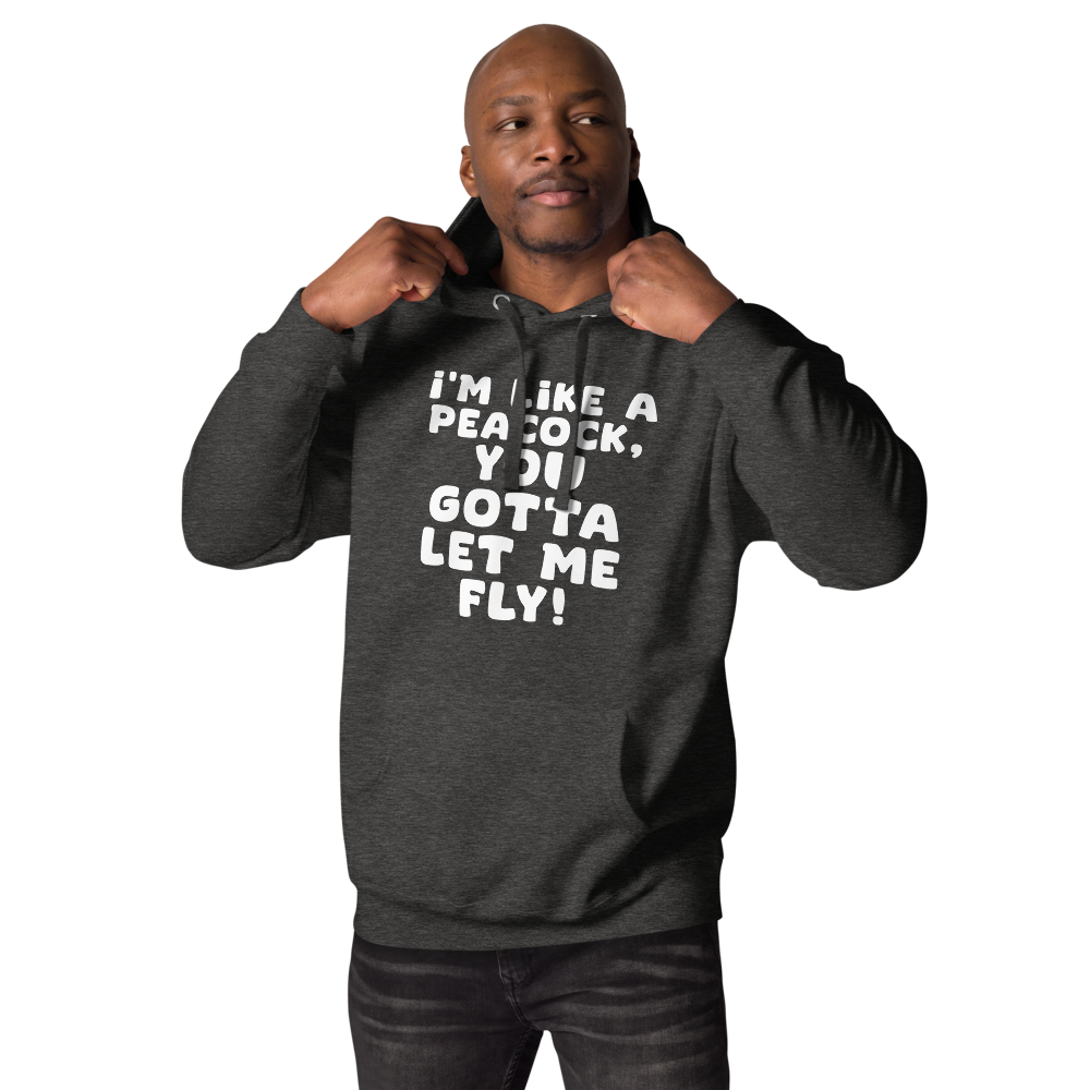 "I'm like a peacock, you gotta let me fly!" printed on a charcoal heather unisex hoodie worn by a male