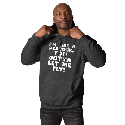 "I'm like a peacock, you gotta let me fly!" printed on a charcoal heather unisex hoodie worn by a male