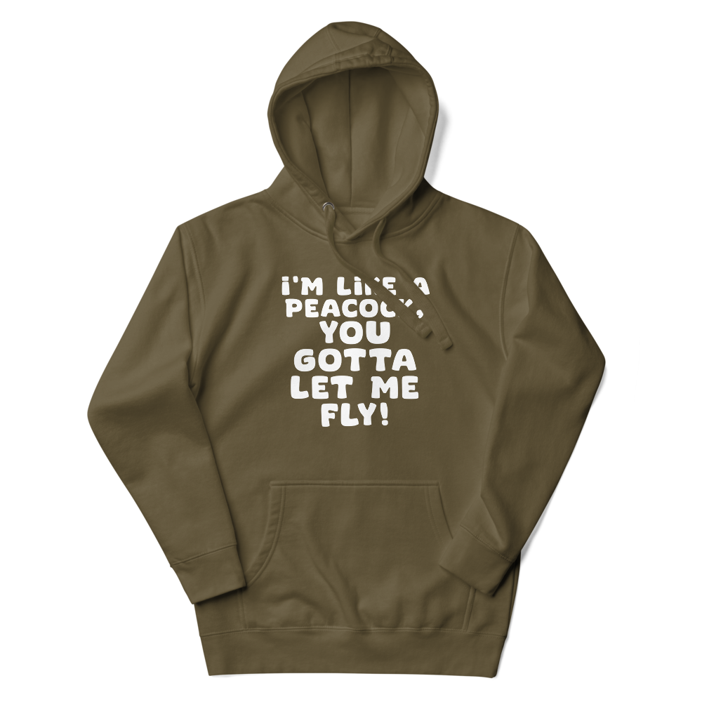 "I'm like a peacock, you gotta let me fly!" printed on a military green unisex hoodie laying on a flat surface with the hood up