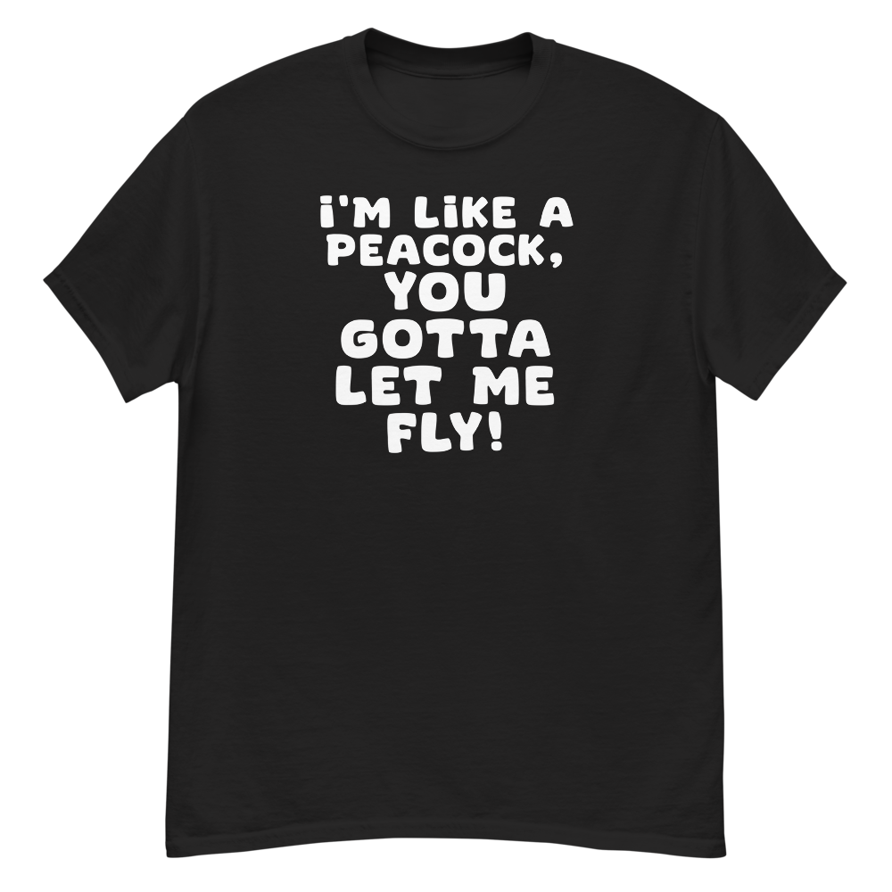 "I'm like a peacock, you gotta let me fly!" printed on a black unisex classic tee laying on a flat surface