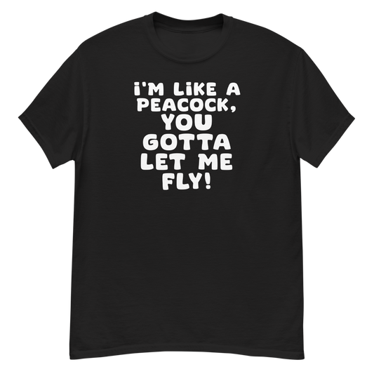 "I'm like a peacock, you gotta let me fly!" printed on a black unisex classic tee laying on a flat surface