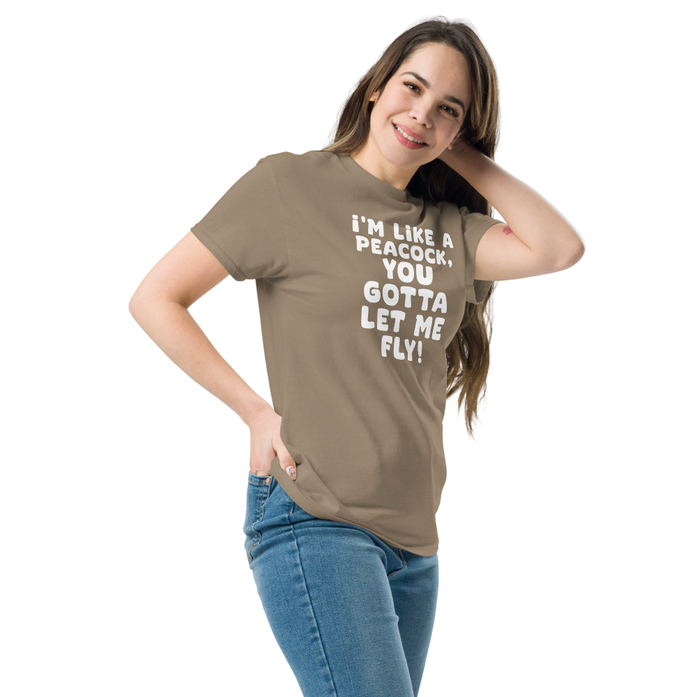 "I'm like a peacock, you gotta let me fly!" printed on a brown savana unisex classic tee worn by a female