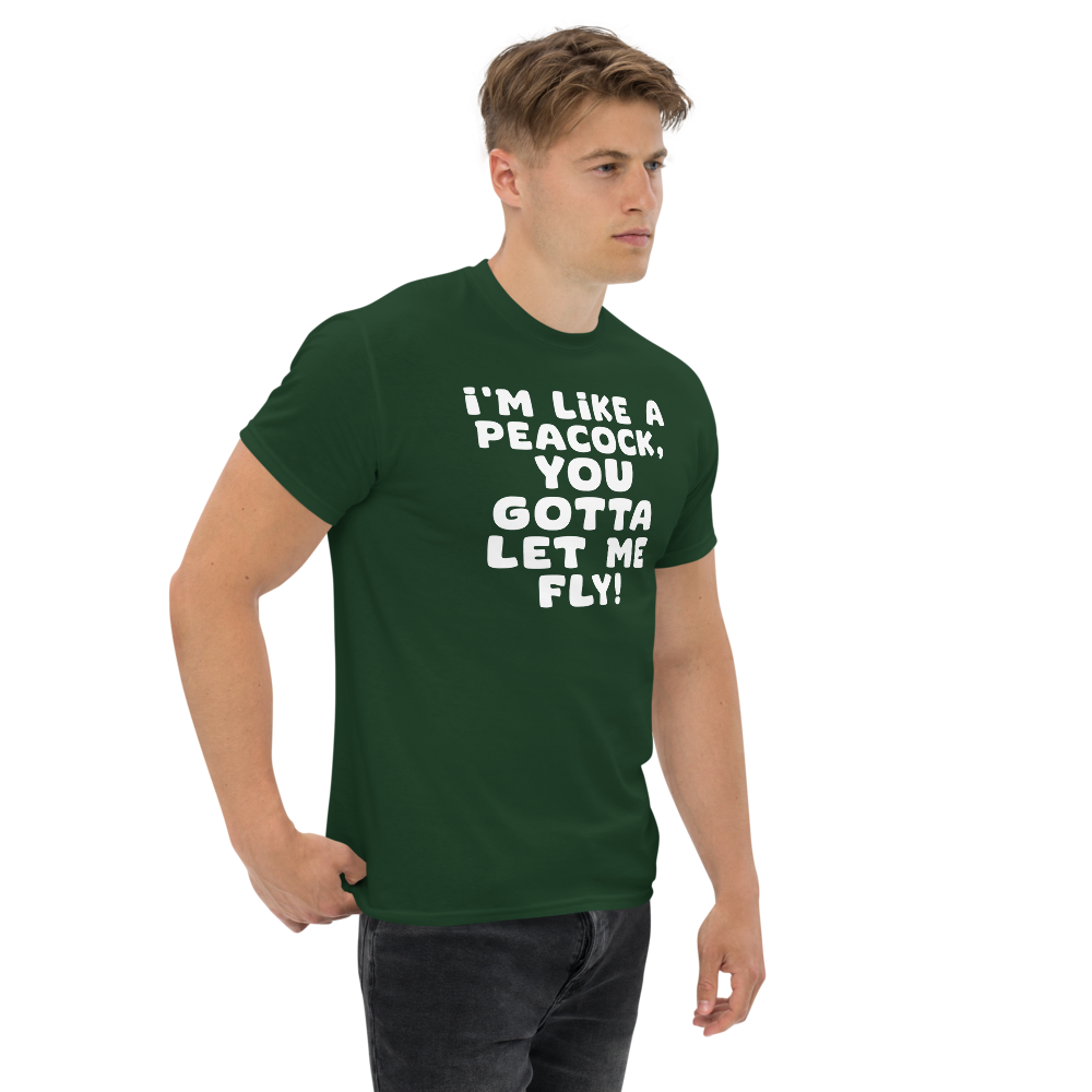 "I'm like a peacock, you gotta let me fly!" printed on a forest green unisex classic tee worn by a male