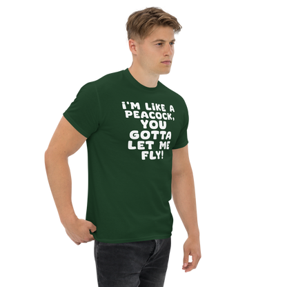 "I'm like a peacock, you gotta let me fly!" printed on a forest green unisex classic tee worn by a male