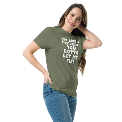 "I'm like a peacock, you gotta let me fly!" printed on a military green unisex classic tee worn by a female