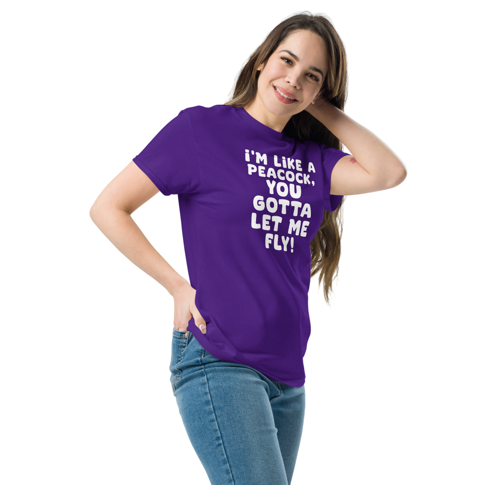 "I'm like a peacock, you gotta let me fly!" printed on a purple unisex classic tee worn by a female