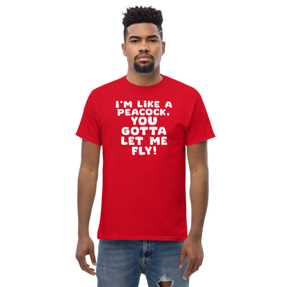 "I'm like a peacock, you gotta let me fly!" printed on a red unisex classic tee worn by a male