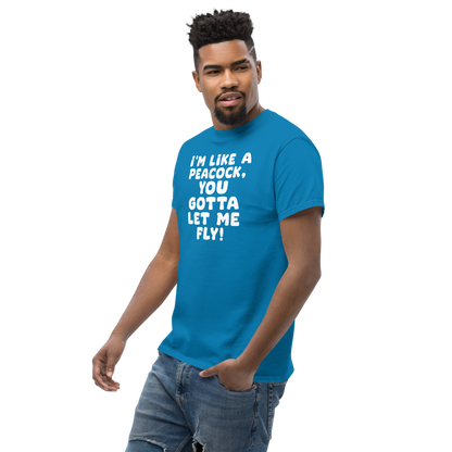 "I'm like a peacock, you gotta let me fly!" printed on a sapphire unisex classic tee worn by a male
