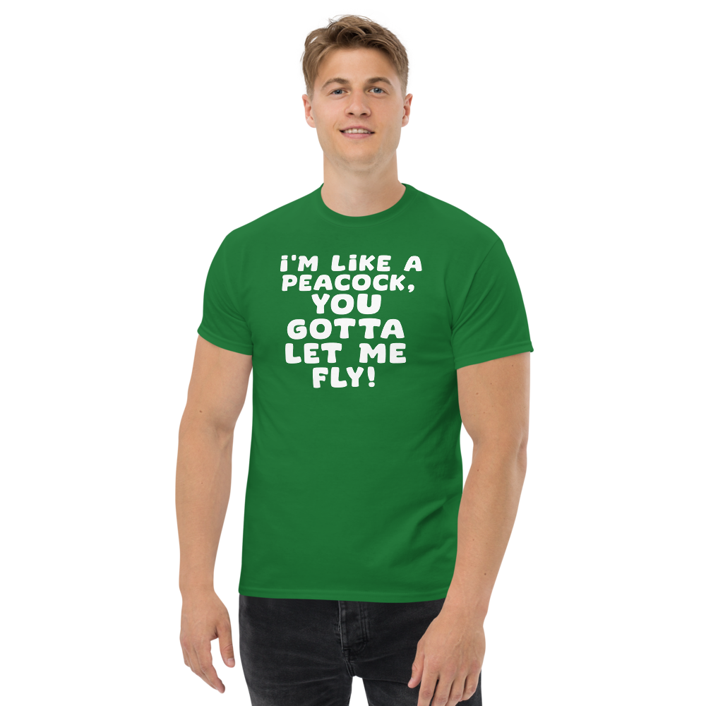 "I'm like a peacock, you gotta let me fly!" printed on a turf green unisex classic tee worn by a male