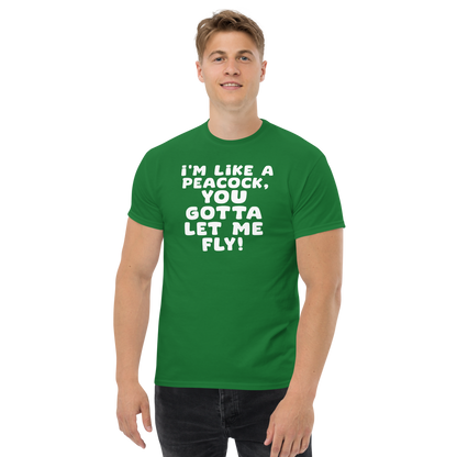 "I'm like a peacock, you gotta let me fly!" printed on a turf green unisex classic tee worn by a male
