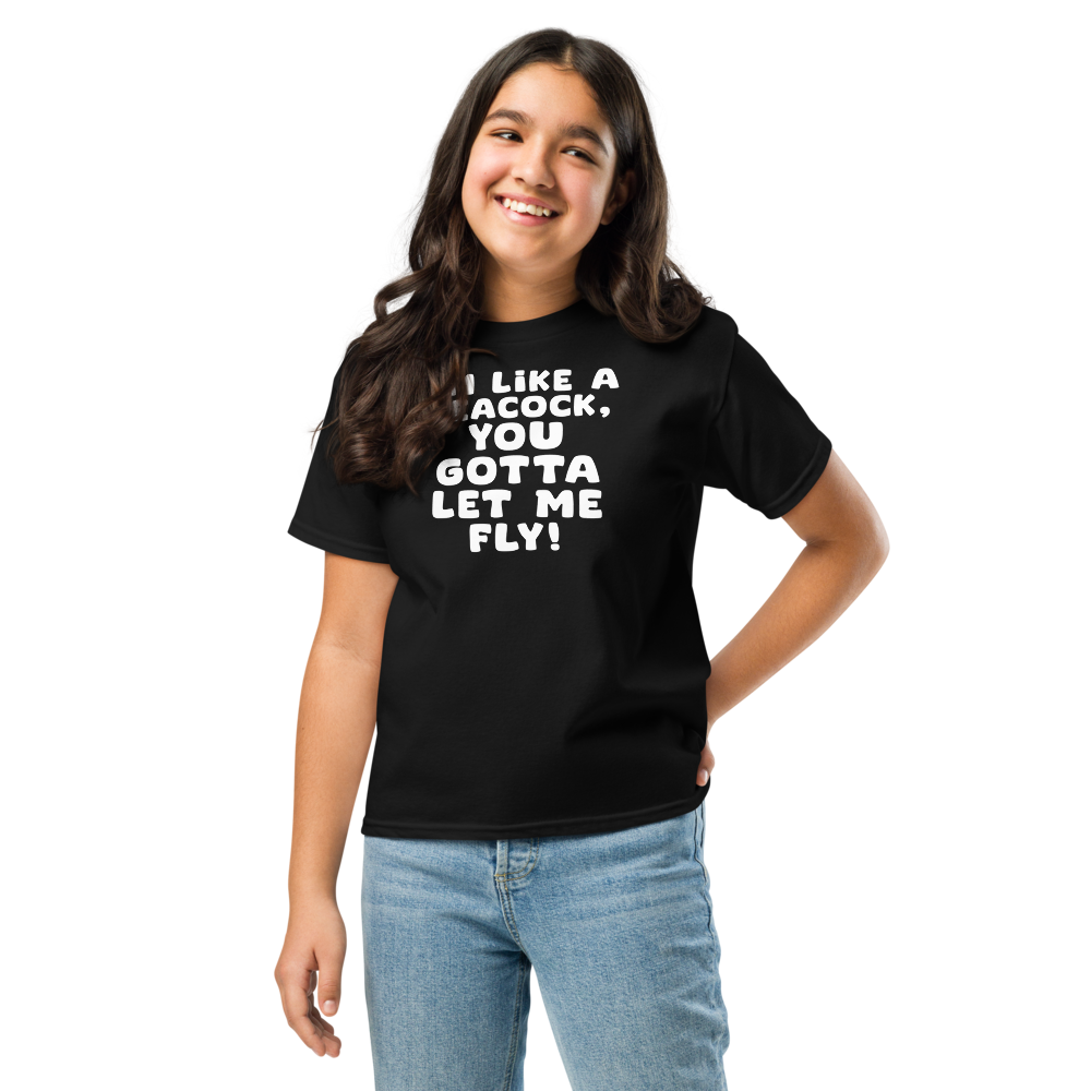 "I'm like a peacock, you gotta let me fly!" printed on a black youth classic tee worn by a female