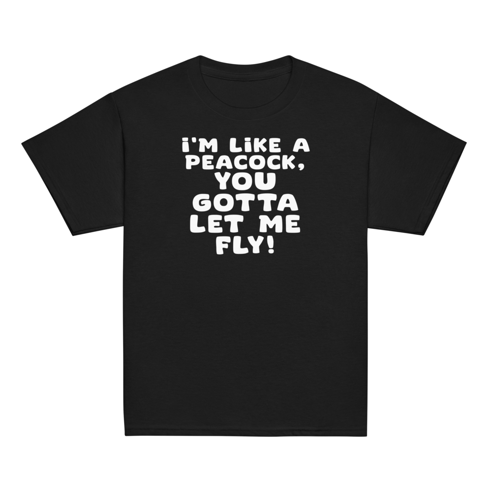 "I'm like a peacock, you gotta let me fly!" printed on a black youth classic tee laying on a flat surface
