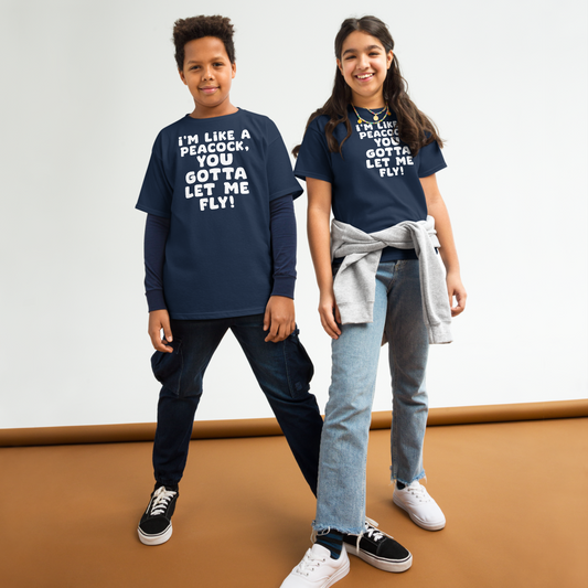 "I'm like a peacock, you gotta let me fly!" printed on a navy youth classic tee worn by a female and male
