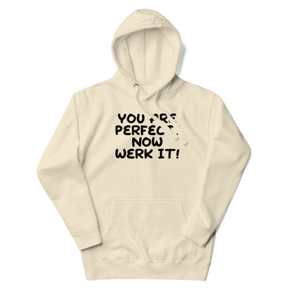 "You Are Perfect! Now Werk It!" printed on a bone unisex hoodie laying on a flat surface with the hood up