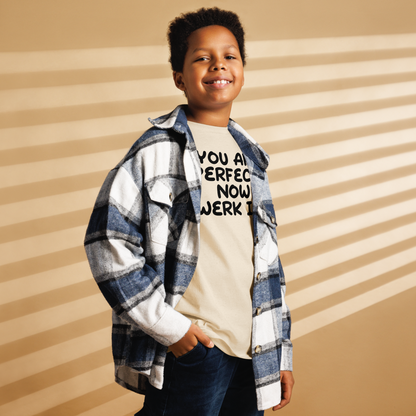 "You Are Perfect! Now Werk It!" printed on a natural youth classic tee worn by a male also wearing a jacket