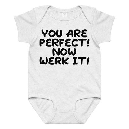 "You Are Perfect! Now Werk It!" printed on a ash baby jersey bodysuit laying on a flat surface amongst other clothes