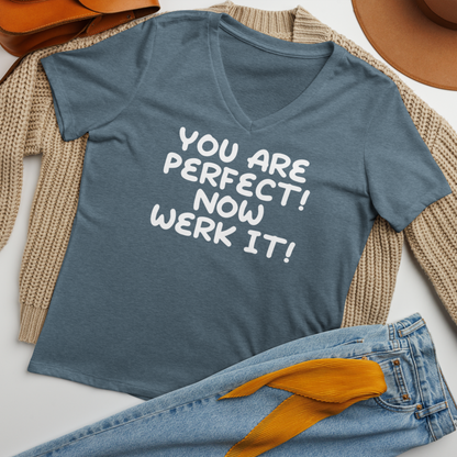 "You Are Perfect! Now Werk It!" printed on a heather slate women's relaxed v-neck t-shirt laying on a flat surface amongst other clothes