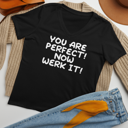 "You Are Perfect! Now Werk It!" printed on a solid black blend women's relaxed v-neck t-shirt laying on a flat surface amongst other clothes