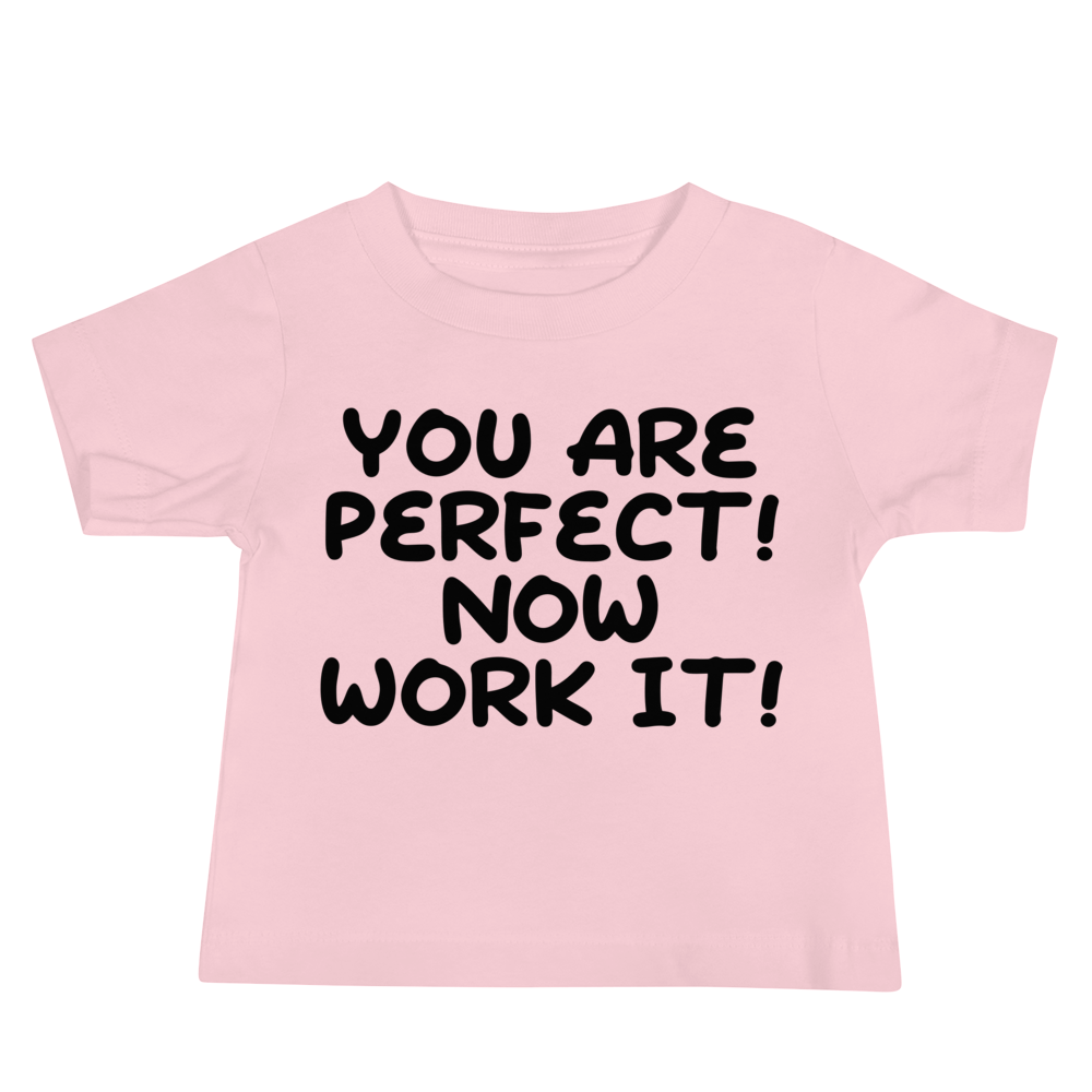 "You Are Perfect! Now Work It!" printed on a pink baby jersey short sleeve tee laying on a flat surface