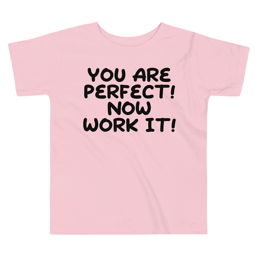 "You Are Perfect! Now Work It!" printed on a pink toddler short sleeve tee laying on a flat surface