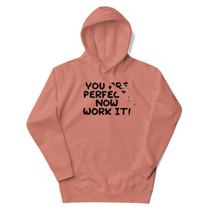 "You Are Perfect! Now Work It!" printed on a dusty rose unisex hoodie laying on a flat surface with the hood up