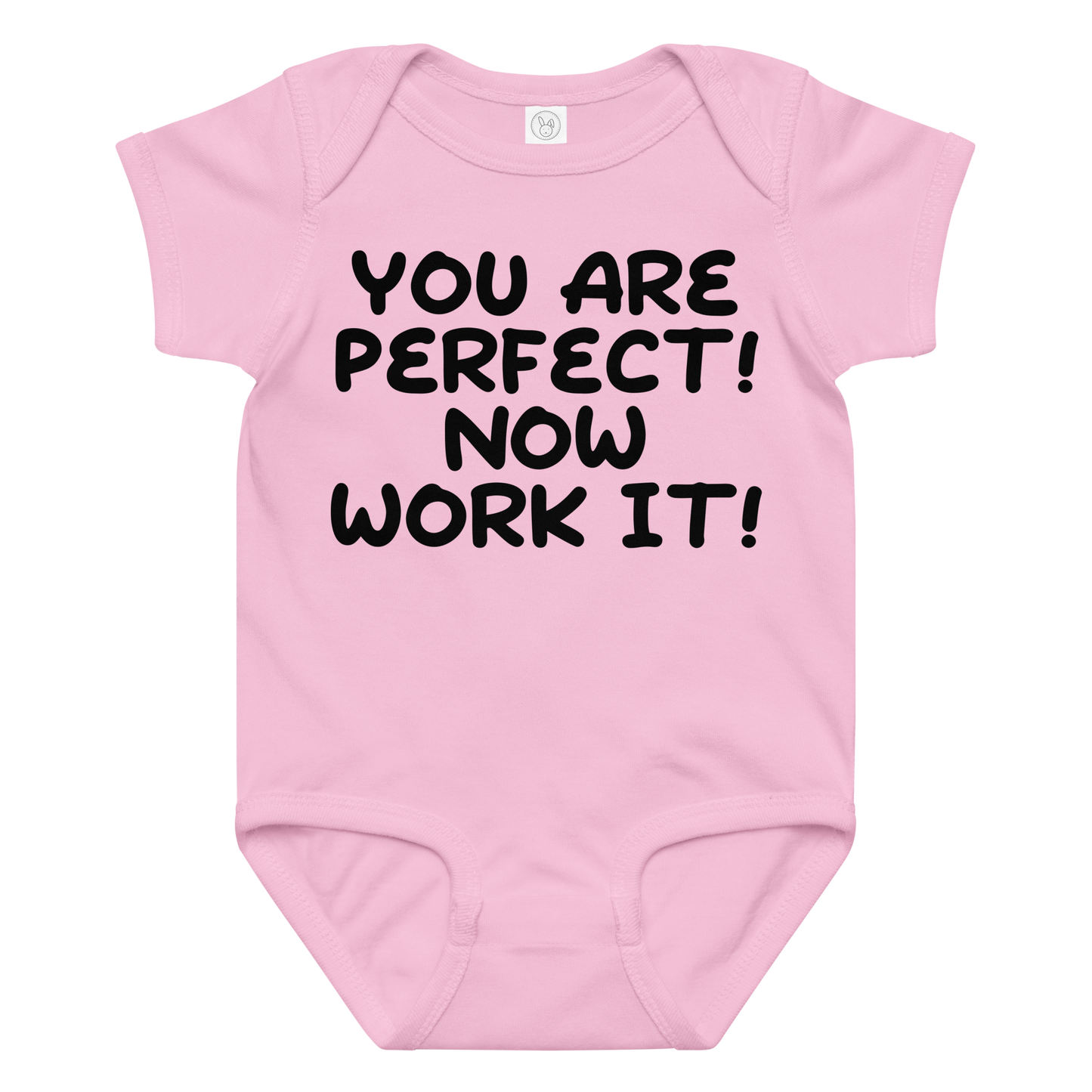 "You Are Perfect! Now Work It!" printed on a pink baby jersey bodysuit laying on a flat surface amongst other clothes