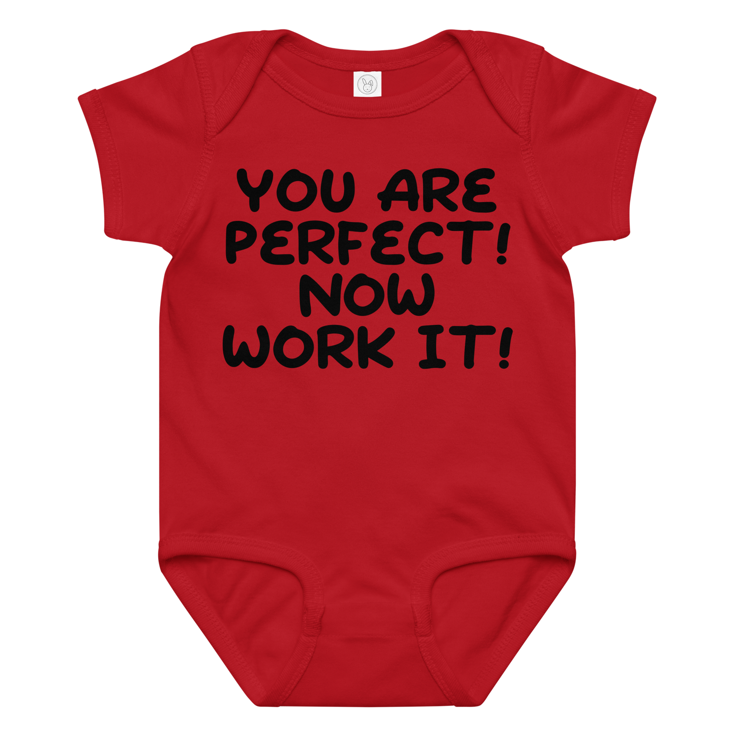 "You Are Perfect! Now Work It!" printed on a red baby jersey bodysuit laying on a flat surface amongst other clothes