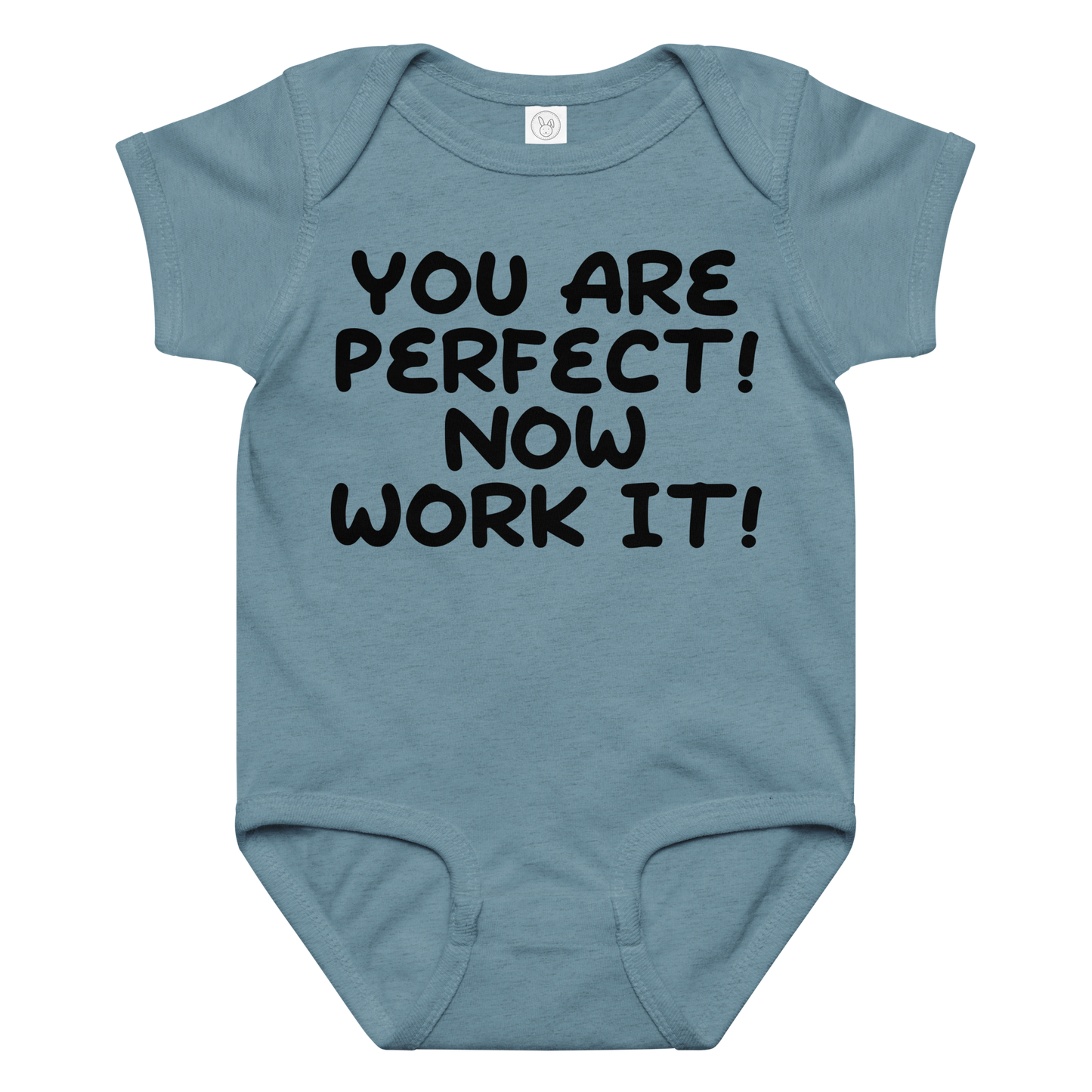 "You Are Perfect! Now Work It!" printed on a vintage indigo baby jersey bodysuit laying on a flat surface amongst other clothes