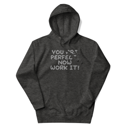 "You Are Perfect! Now Work It!" printed on a charcoal heather unisex hoodie laying on a flat surface with the hood up