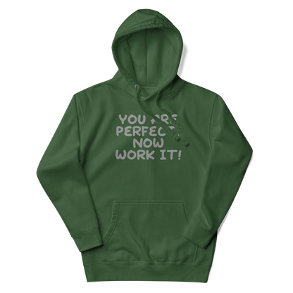 "You Are Perfect! Now Work It!" printed on a forest green unisex hoodie laying on a flat surface with the hood up