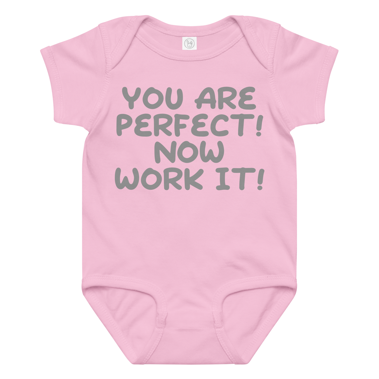 "You Are Perfect! Now Work It!" printed on a pink baby jersey bodysuit laying on a flat surface amongst other clothes