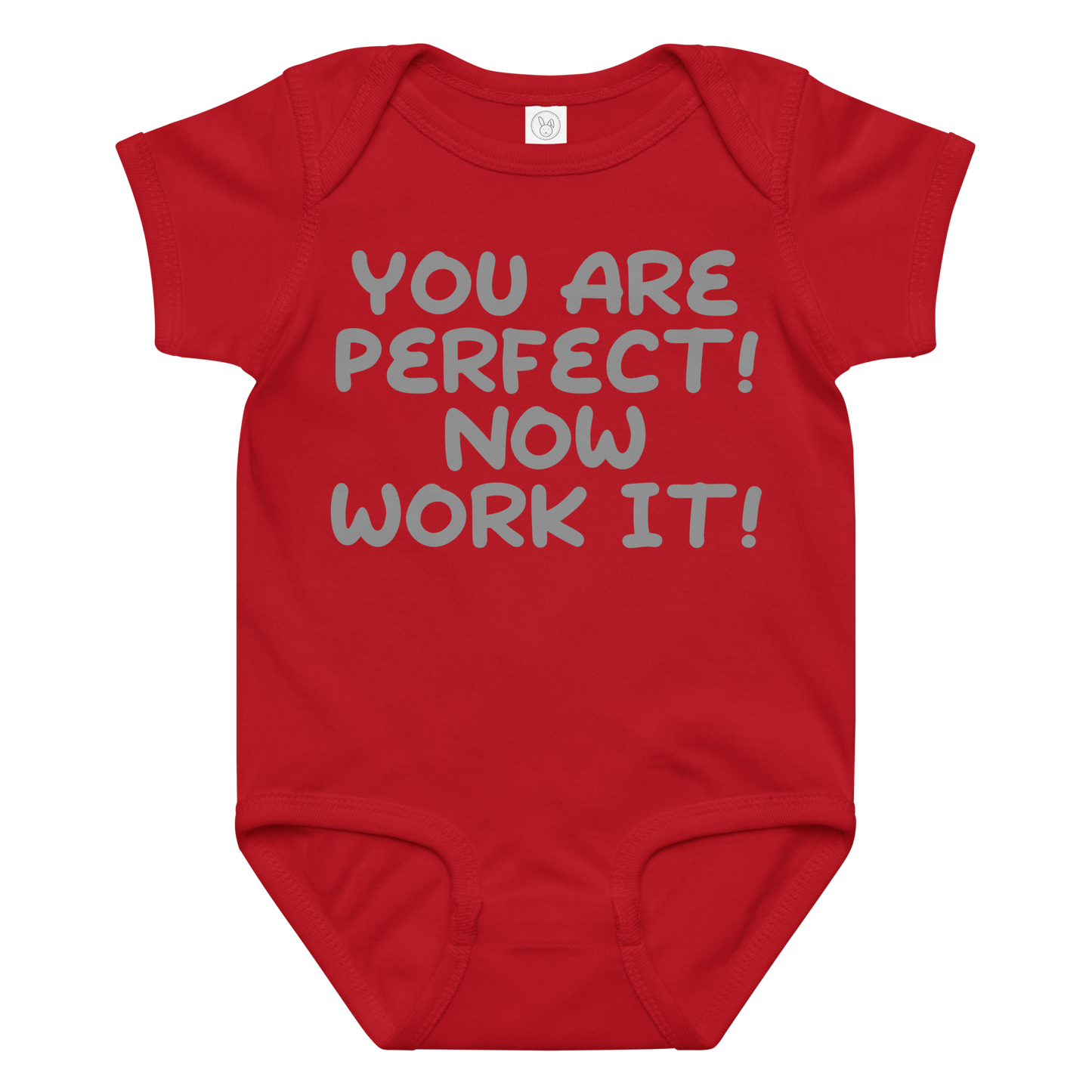 "You Are Perfect! Now Work It!" printed on a red baby jersey bodysuit laying on a flat surface amongst other clothes