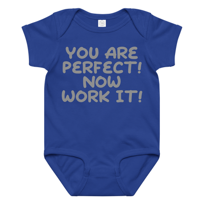 "You Are Perfect! Now Work It!" printed on a royal baby jersey bodysuit laying on a flat surface amongst other clothes