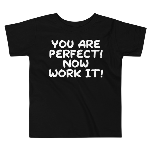 "You Are Perfect! Now Work It!" printed on a black toddler short sleeve tee laying on a flat surface