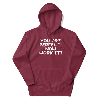 "You Are Perfect! Now Work It!" printed on a maroon unisex hoodie laying on a flat surface with the hood up