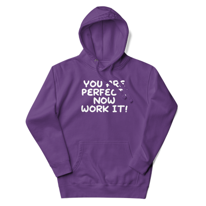 "You Are Perfect! Now Work It!" printed on a purple unisex hoodie laying on a flat surface with the hood up