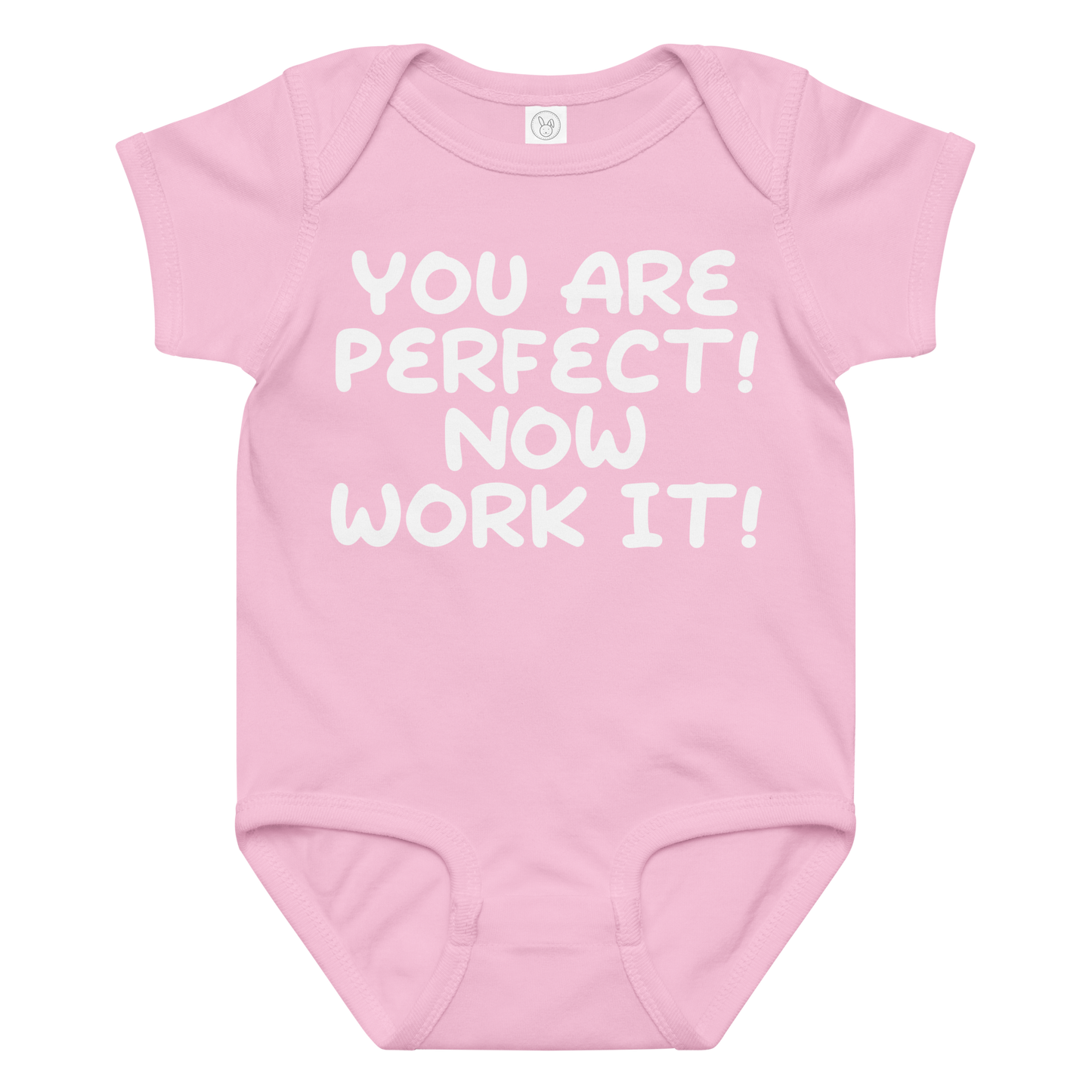 "You Are Perfect! Now Work It!" printed on a pink baby jersey bodysuit laying on a flat surface amongst other clothes