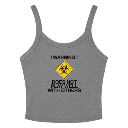 "!Warning! Does Not Play Well With Others" printed on a athletic heather women's micro-rib tanktop laying on a flat surface amongst sunglasses and shorts