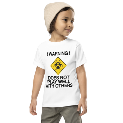 "!Warning! Does Not Play Well With Others" printed on a white toddler short sleeve tee worn by a male wearing a cap