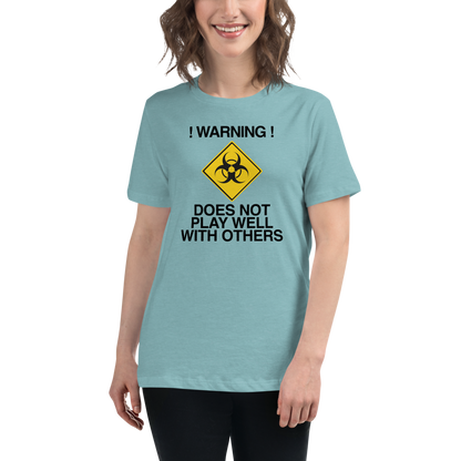 "!Warning! Does Not Play Well With Others" printed on a heather blue lagoon women's relaxed t-shirt worn by a female